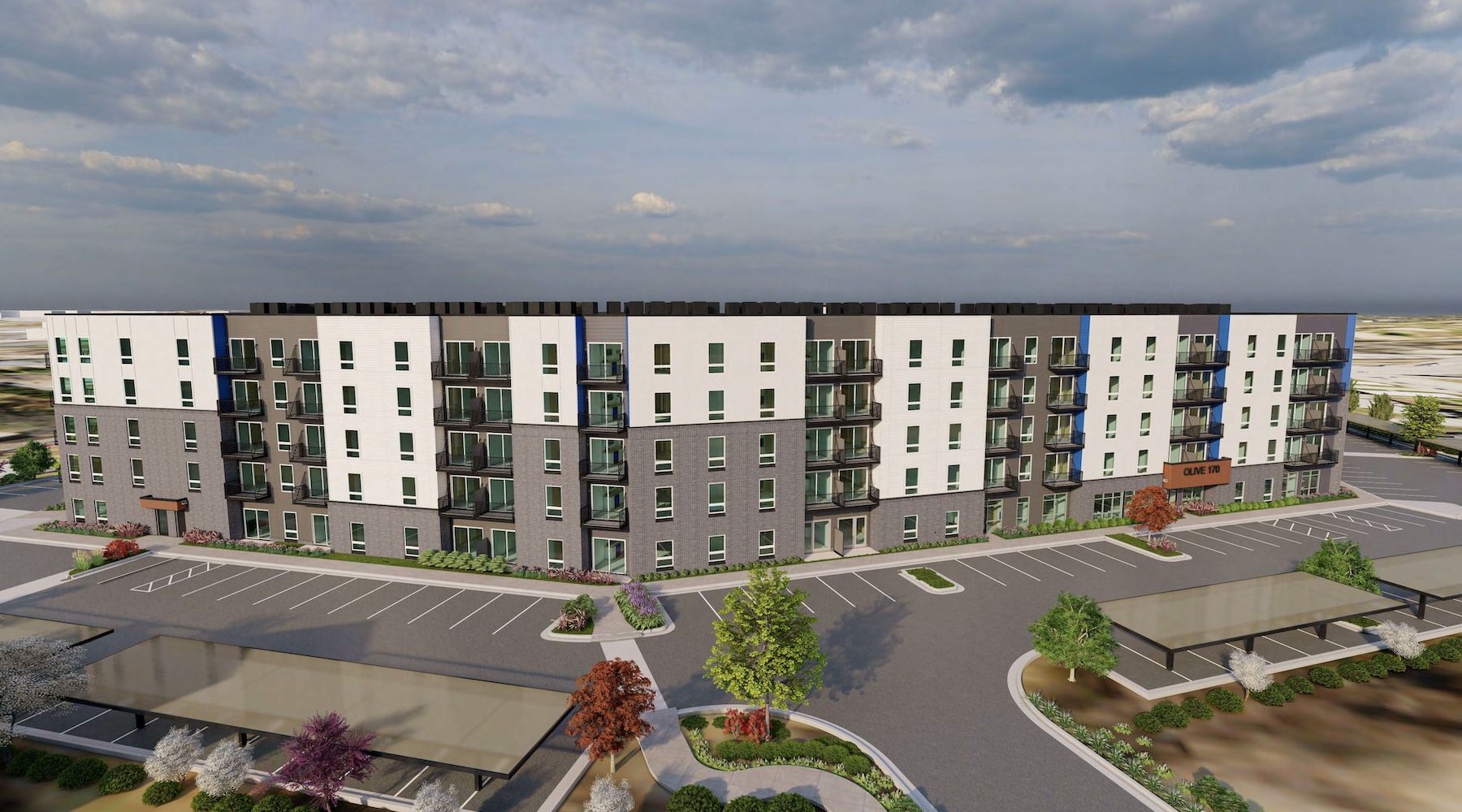 an aerial view of an apartment building with a parking lot